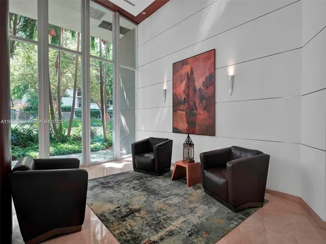 a lobby with furniture and floor to ceiling window