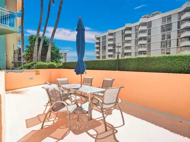 a view of swimming pool with outdoor seating and city view
