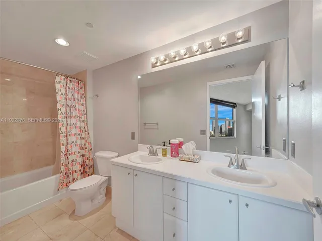 a bathroom with a sink double vanity and tub
