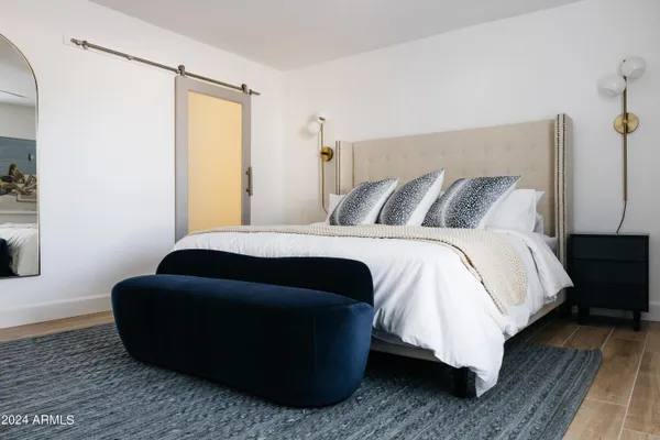 a bedroom with a bed and wooden floor