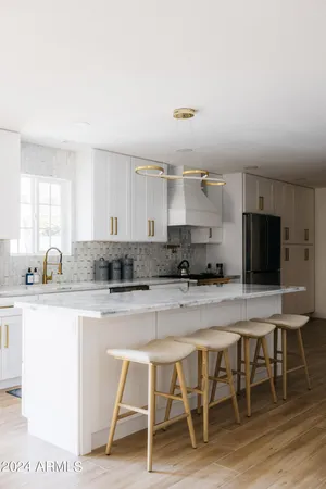 a kitchen with a refrigerator stove and wooden cabinets