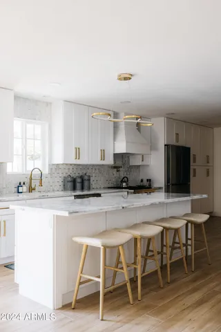 a kitchen with a refrigerator stove and wooden cabinets