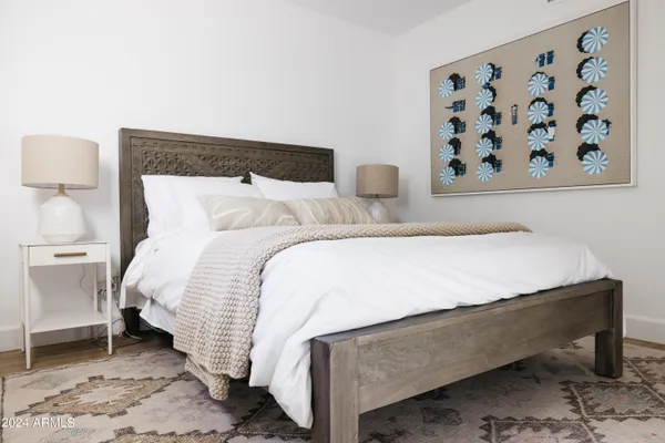 a bedroom with a bed and a night stand