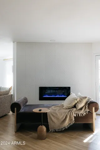 a kitchen with stainless steel appliances granite countertop a stove top oven a sink a dining table and chairs