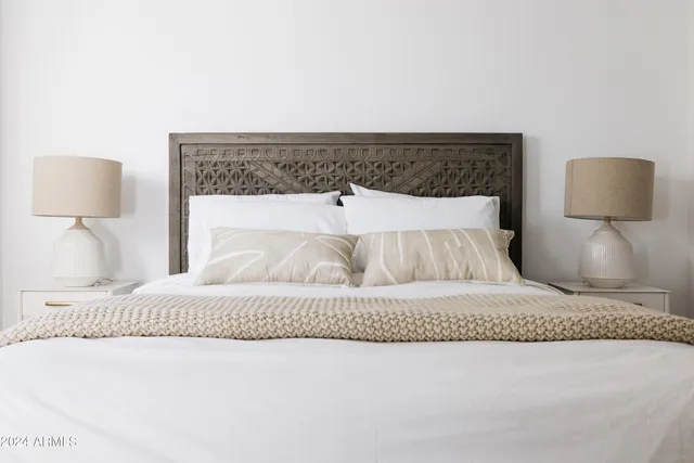 a bedroom with a bed and a lamp