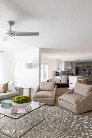 a living room with furniture and a lamp