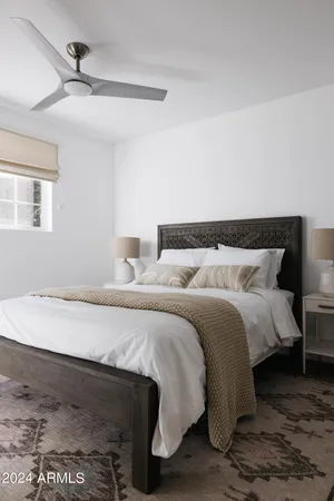 a bedroom with a bed and a night stand