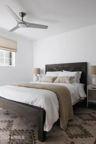 a bedroom with a bed and a night stand