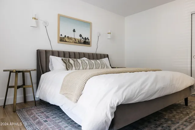 a large white bed sitting in a bedroom