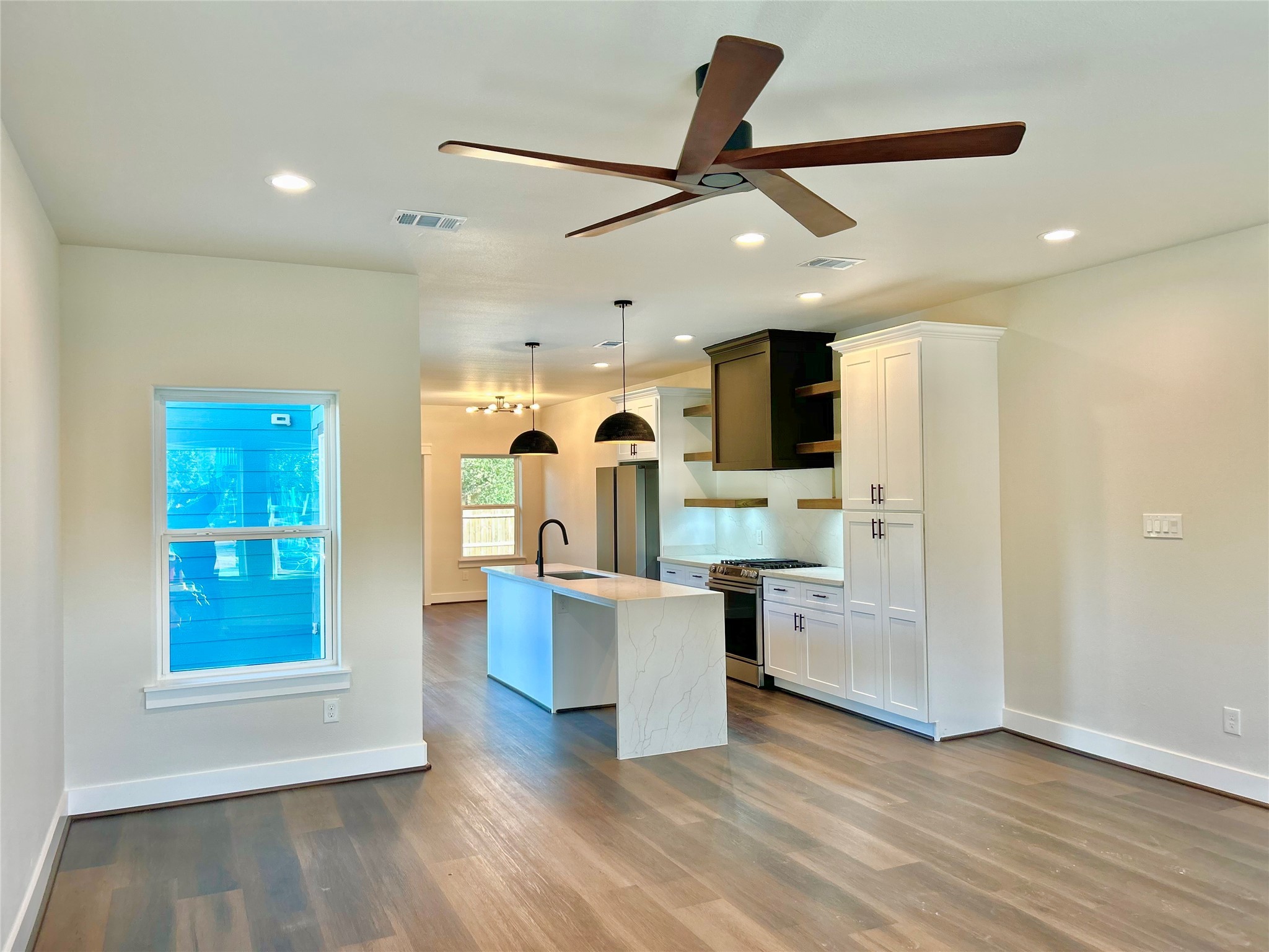 125 4th Street San Leon, TX 77539 - Photo 3 of 40 a living room with stainless steel appliances kitchen island hardwood floor and a view of kitchen