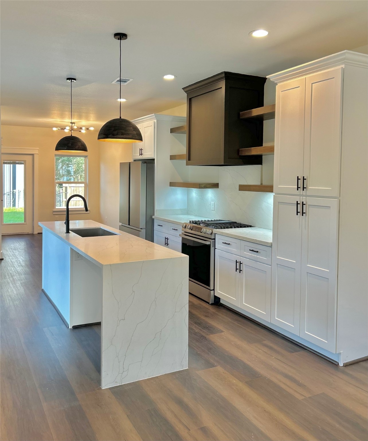 125 4th Street San Leon, TX 77539 - Photo 4 of 40 a large kitchen with stainless steel appliances a large counter top a stove a refrigerator and a sink