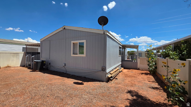1450 North Dixie Downs Road, Unit 51 St. George, UT 84770 - Photo 13 of 25 Exterior featuring light blue siding, a white trim window, and a gray deck with white railings