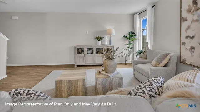 a living room with furniture and kitchen view