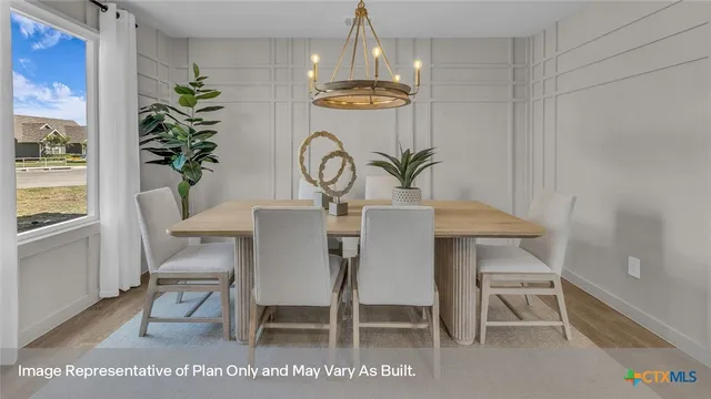 a view of a dining room with furniture a chandelier and wooden floor