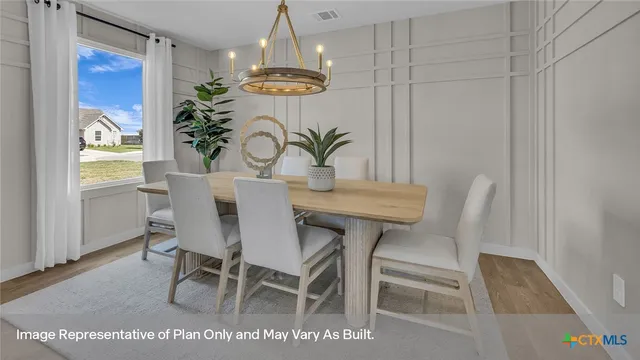 a view of a dining room with furniture and a chandelier