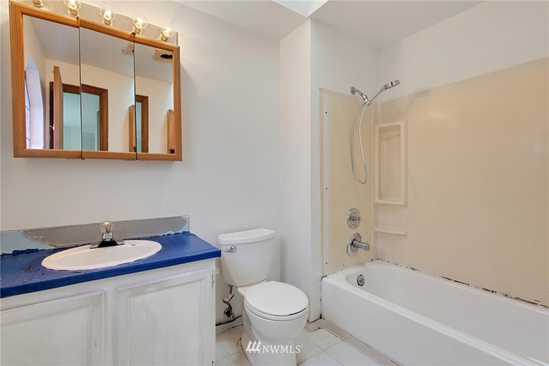 1230 224th Place Southwest Bothell, WA 98021 - Photo 18 of 22 a bathroom with a sink toilet a mirror and shower