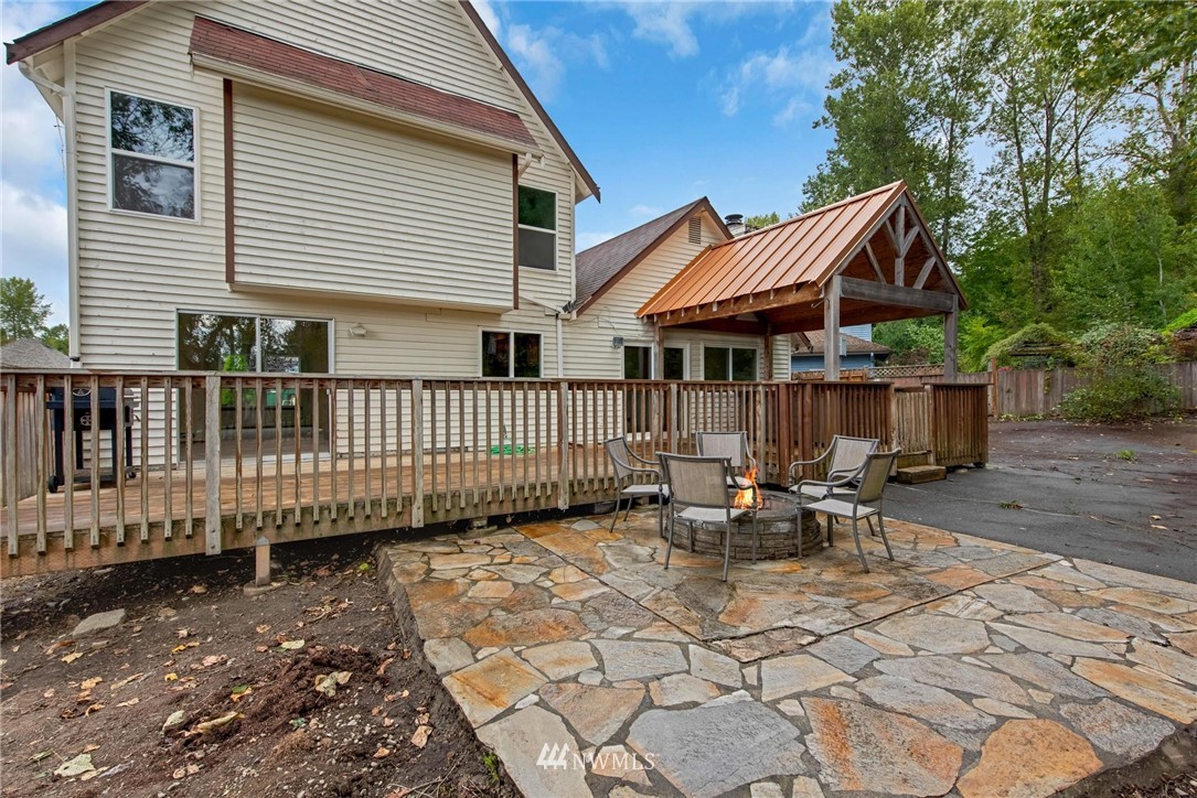 1230 224th Place Southwest Bothell, WA 98021 - Photo 19 of 22 a view of a house with wooden deck and furniture