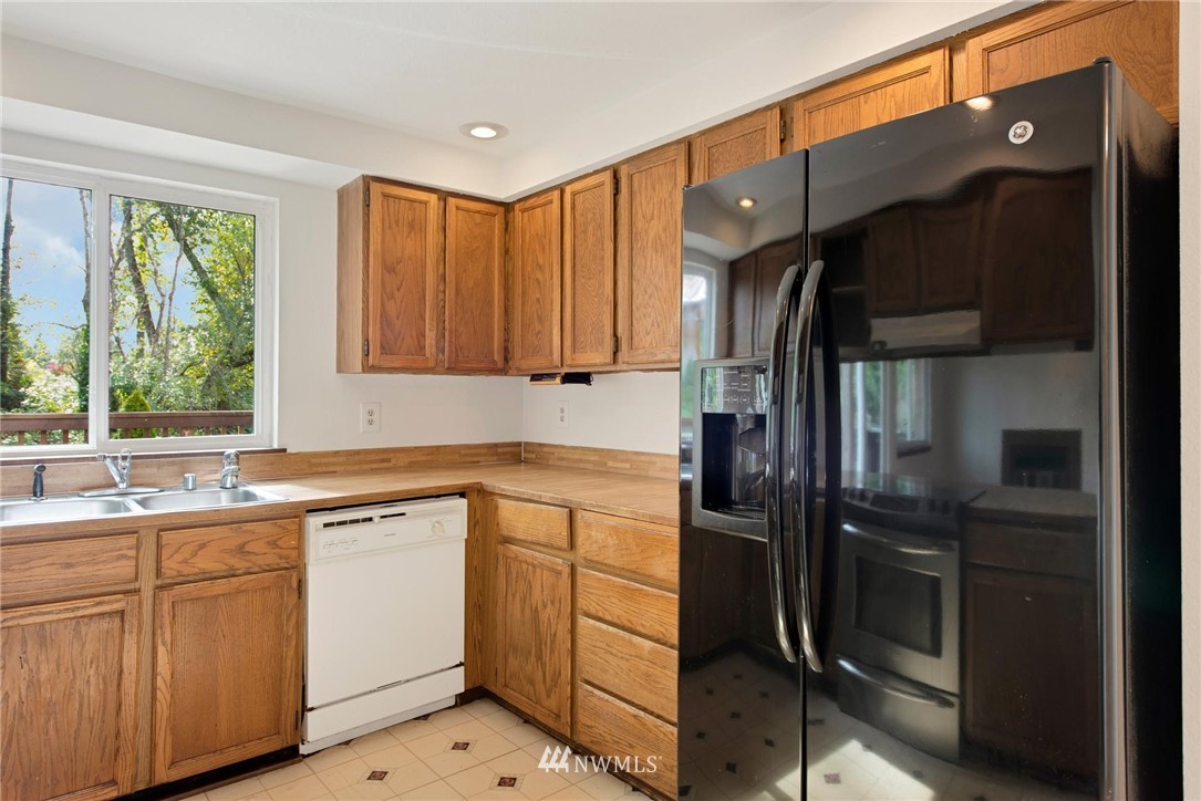 1230 224th Place Southwest Bothell, WA 98021 - Photo 7 of 22 a kitchen with white cabinets and appliances