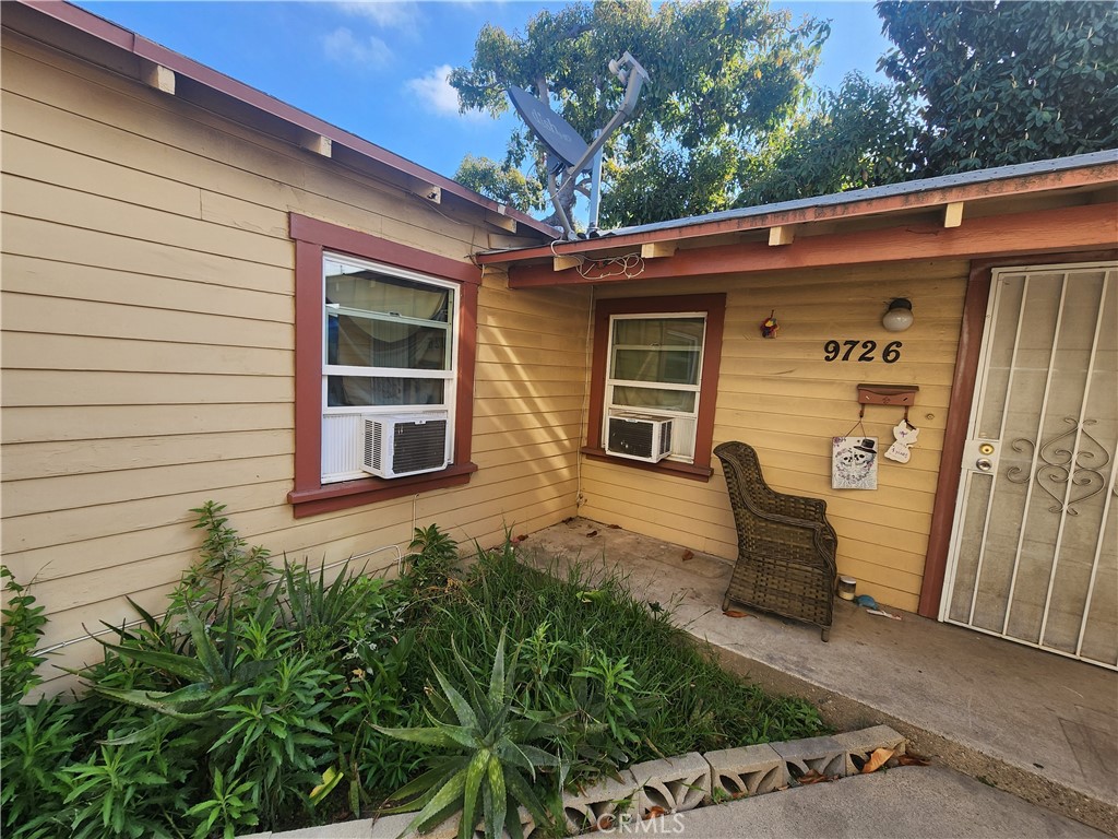 9724 Walnut Street Bellflower, CA 90706 - Photo 4 of 4 a front view of a house with a garage