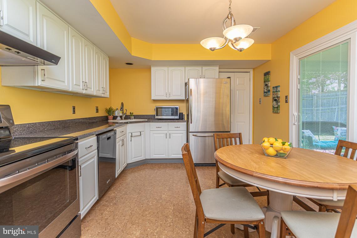 2064 Fort Bevon Road Harleysville, PA 19438 - Photo 12 of 25 a kitchen with a table chairs sink and cabinets
