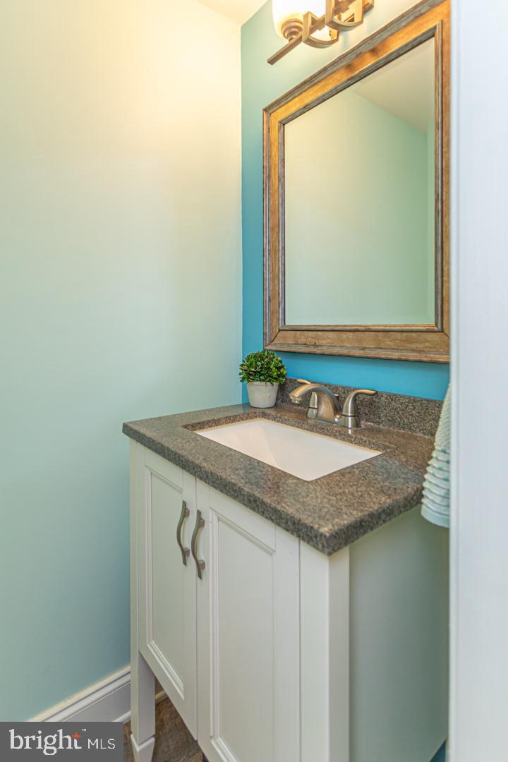 2064 Fort Bevon Road Harleysville, PA 19438 - Photo 13 of 25 a bathroom with a granite countertop sink and a mirror