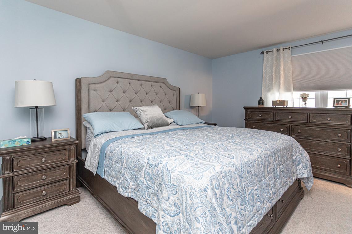 2064 Fort Bevon Road Harleysville, PA 19438 - Photo 14 of 25 a bedroom with a bed and a lamp on dresser