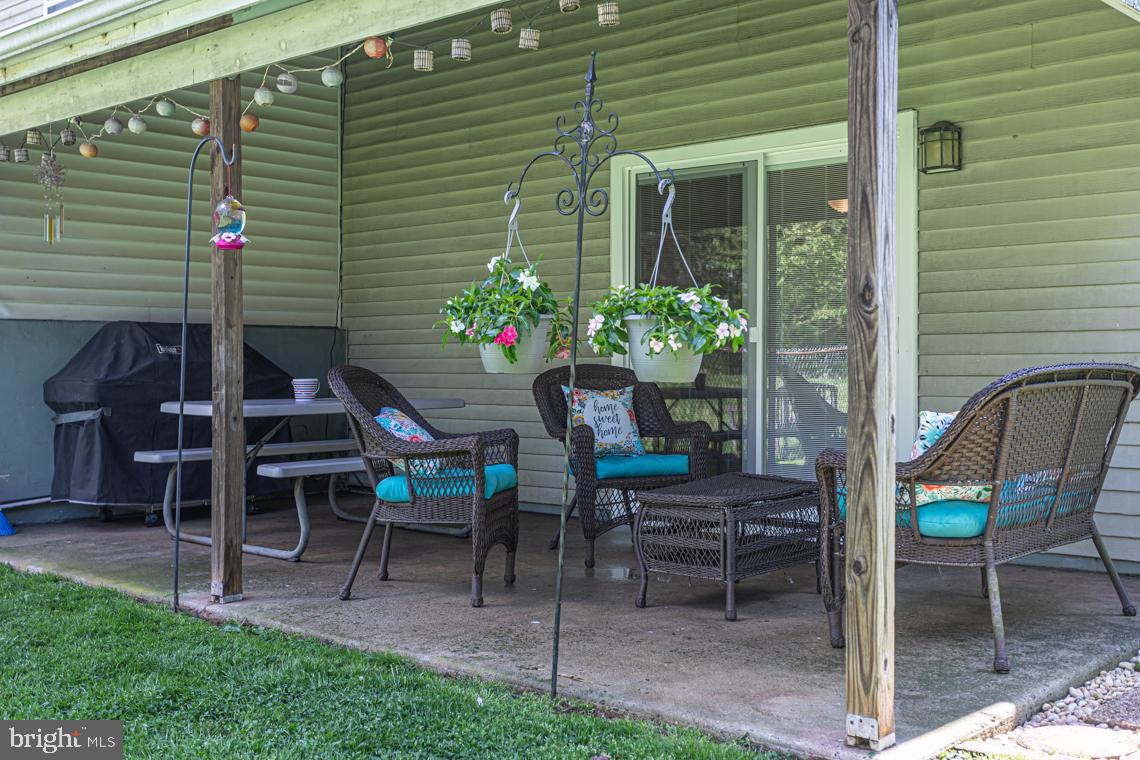 2064 Fort Bevon Road Harleysville, PA 19438 - Photo 22 of 25 a view of a patio with a table and chairs and a potted plant