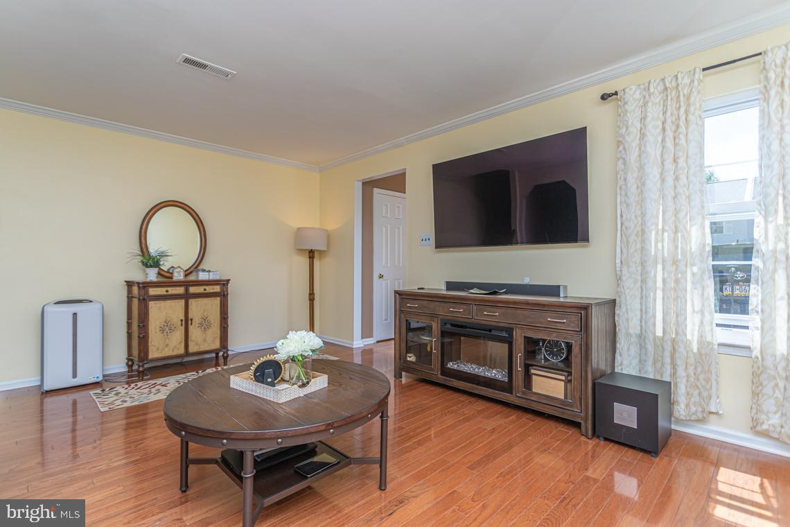 2064 Fort Bevon Road Harleysville, PA 19438 - Photo 5 of 25 a living room with furniture a fireplace and a flat screen tv