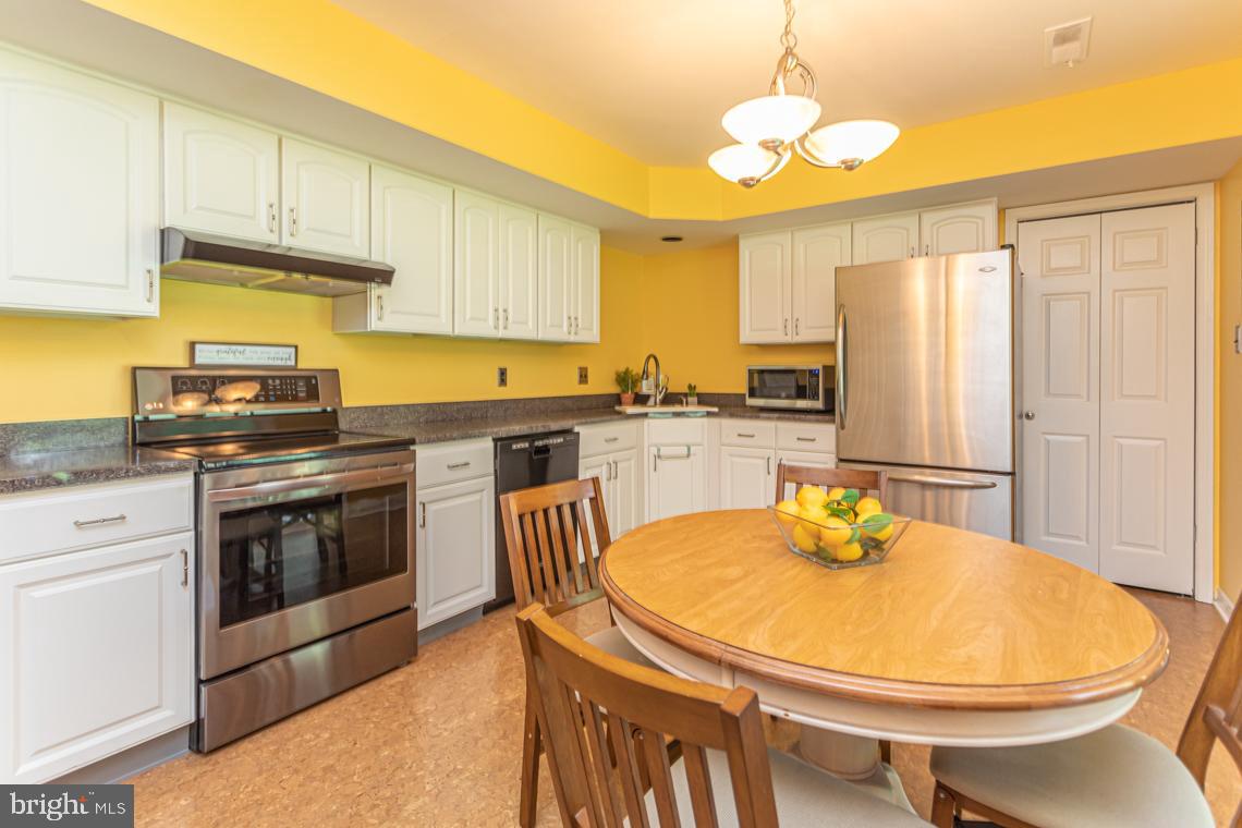 2064 Fort Bevon Road Harleysville, PA 19438 - Photo 9 of 25 a kitchen with a sink a stove and chairs