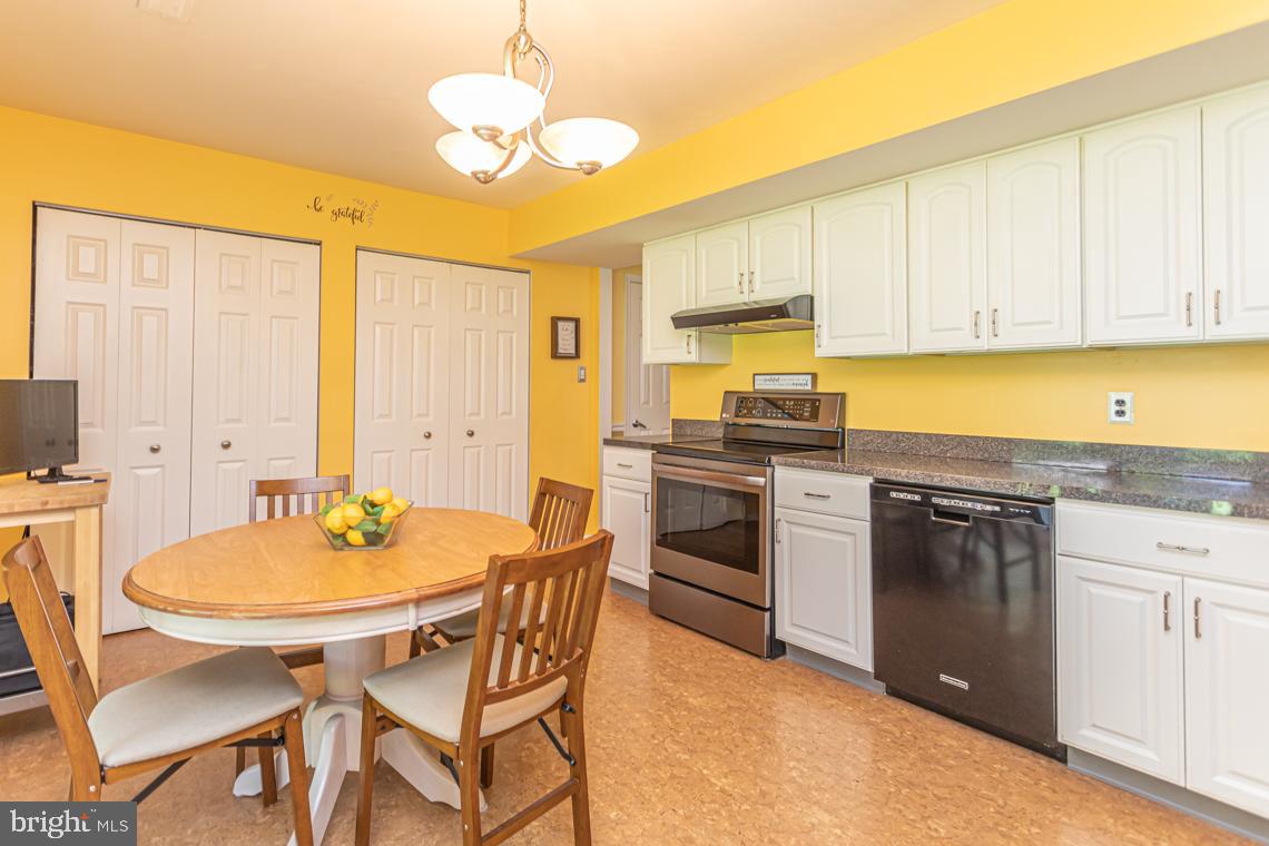 2064 Fort Bevon Road Harleysville, PA 19438 - Photo 10 of 25 a kitchen with stainless steel appliances a stove a sink dishwasher and a refrigerator with wooden floor