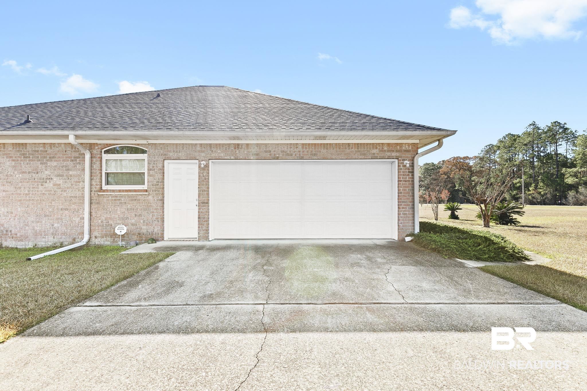 24130 Cowling Road Robertsdale, AL 36567 - Photo 50 of 71 Exterior space with a lawn and a garage