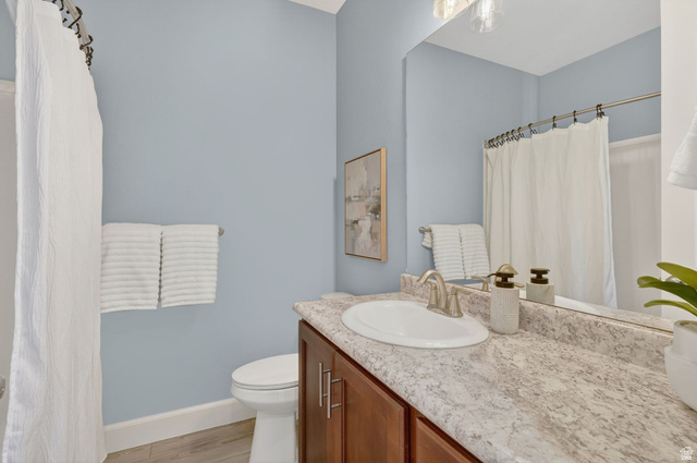 1222 West 190th Street North Mapleton, UT 84664 - Photo 22 of 46 Bathroom featuring a single vanity with an integrated sink, laminate countertop, and wood-finish cabinetry