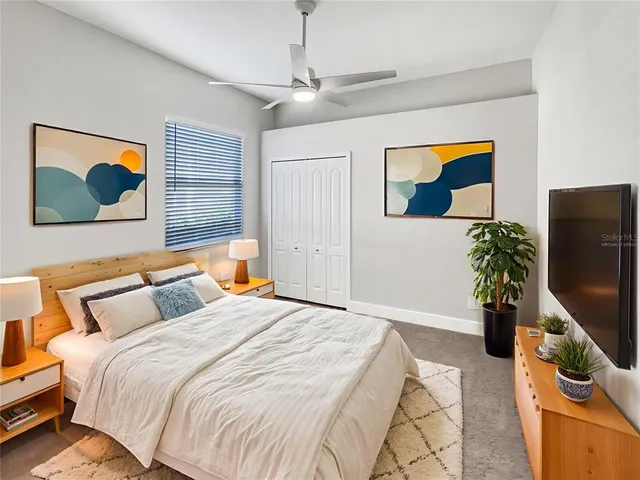 a bedroom with a bed and a flat screen tv