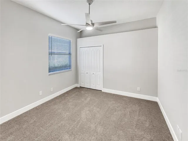 an empty room with windows and closet