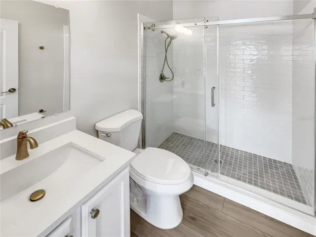 a bathroom with a sink toilet and shower