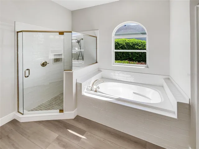 a bathroom with a bathtub and a shower