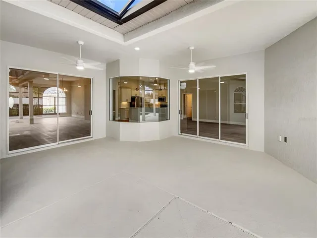 an empty room with entrance and windows