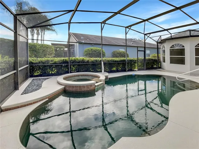 a view of a patio with table and chairs potted plants with floor to ceiling window