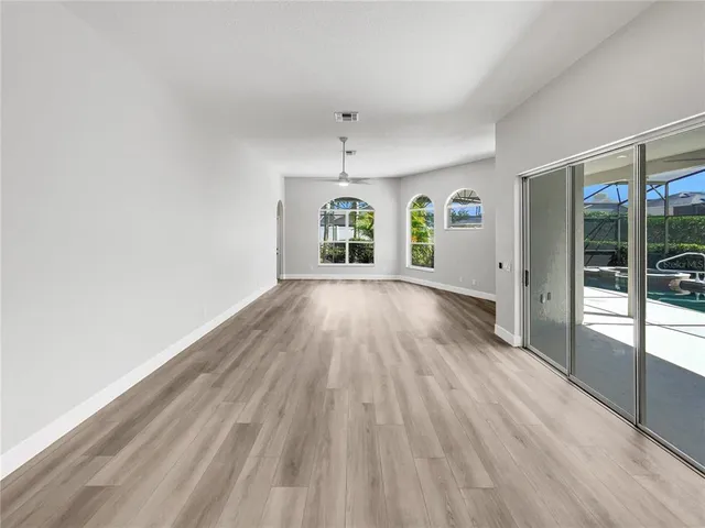 wooden floor in an empty room with a window