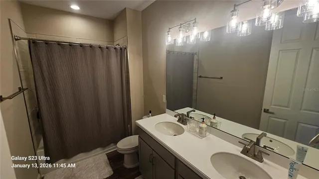 a bathroom with a sink vanity granite and toilet