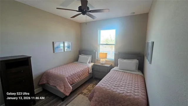 a bedroom with two beds and a window