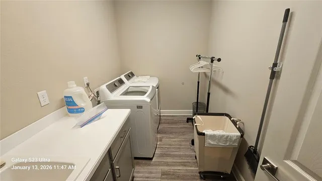 a utility room with sink dryer and washer