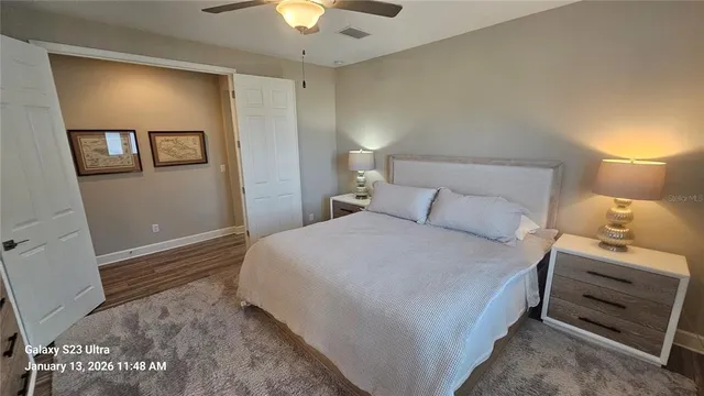 a bedroom with a bed and a lamp