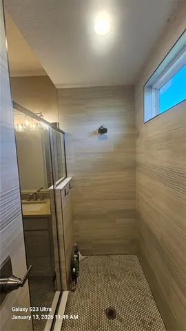 a view of a dining room with furniture a chandelier and wooden floor