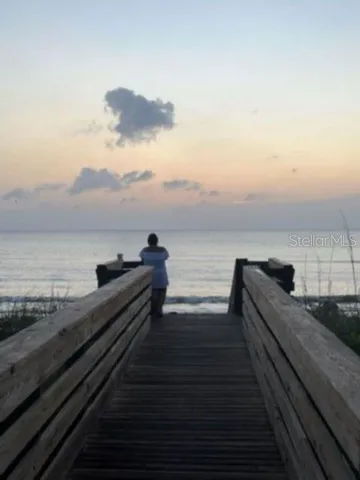 a view of swimming pool with a garden and trees