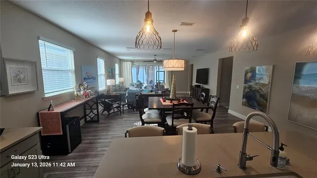 a living room with furniture a chandelier and a large window