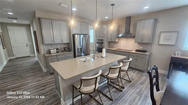 a large kitchen with a table and chairs