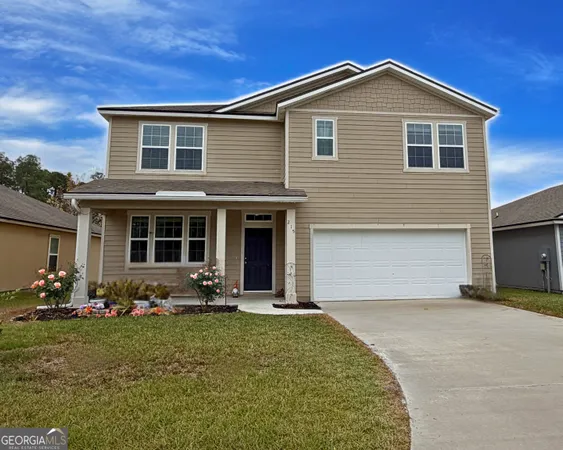 a front view of a house with sitting area
