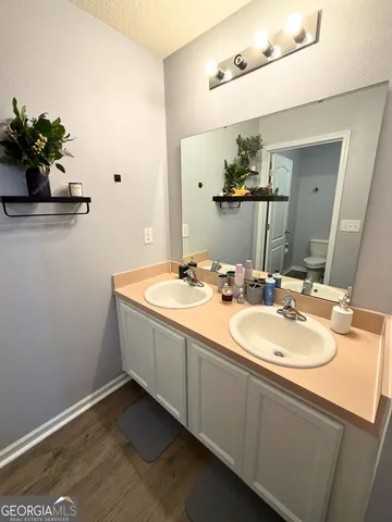 a bathroom with a double vanity sink and a mirror