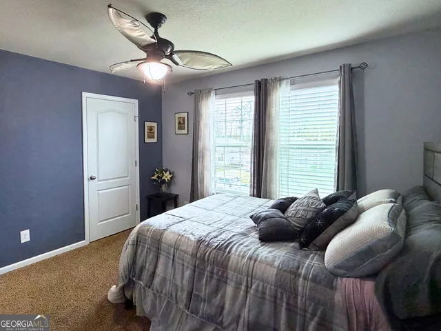 a bedroom with a bed and window